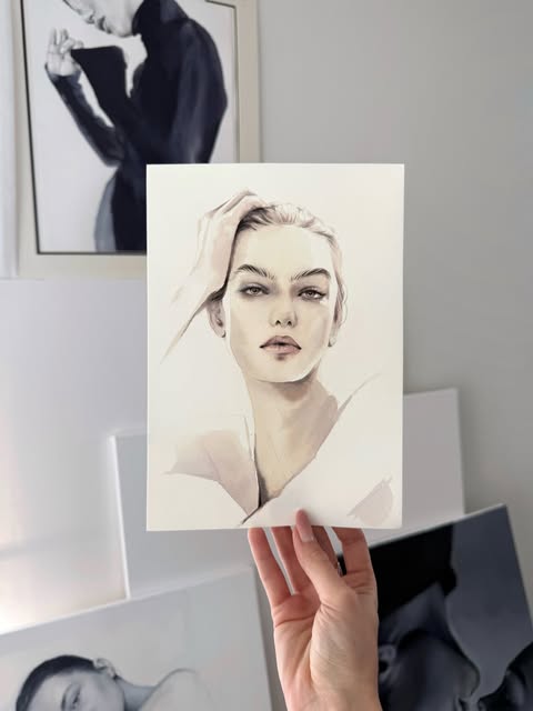 A delicate portrait illustration held against a studio wall